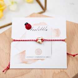 Butterfly March Bracelet March bracelet made of red-white cord with enamel butterfly