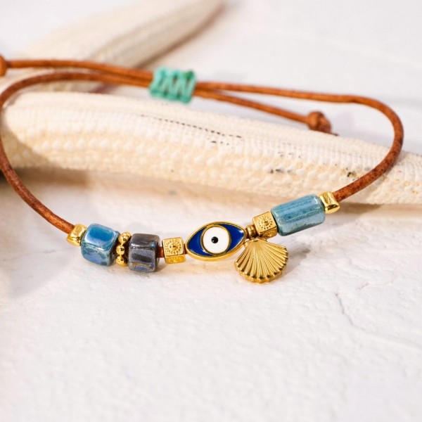 Macrame bracelet with gold-plated enamelled evil eye Handmade macrame bracelet with gold-plated enamelled evil eye