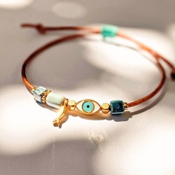 Macrame bracelet with gold-plated enamelled metal evil eye Handmade macrame bracelet with gold-plated enamelled metal evil eye