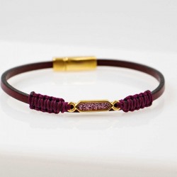 Handmade leather bracelet with gold-plated metal parts and glittered enamel Handmade leather bracelet with gold-plated metal parts and glittered enamel