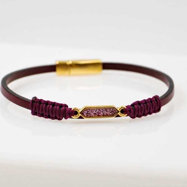 Handmade leather bracelet with gold-plated metal parts and glittered enamel Handmade leather bracelet with gold-plated metal parts and glittered enamel