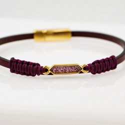 Handmade leather bracelet with gold-plated metal parts and glittered enamel Handmade leather bracelet with gold-plated metal parts and glittered enamel