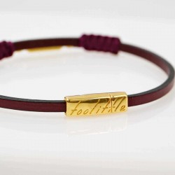 Handmade leather bracelet with gold-plated metal parts and glittered enamel Handmade leather bracelet with gold-plated metal parts and glittered enamel