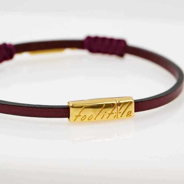 Handmade leather bracelet with gold-plated metal parts and glittered enamel Handmade leather bracelet with gold-plated metal parts and glittered enamel