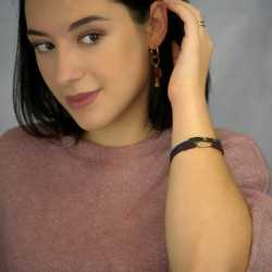 Handmade leather bracelet with gold-plated metal parts and glittered enamel Handmade leather bracelet with gold-plated metal parts and glittered enamel