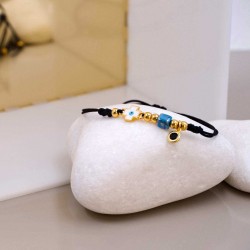 Macrame bracelet with gold-plated enamelled evil eye cross Handmade macrame bracelet with gold-plated enamelled evil eye cross