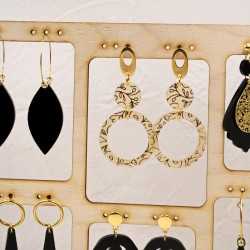 Stand with handmade pairs of earrings with gold-plating and plexiglass parts Stand with handmade pairs of earrings with gold-plating and plexiglass parts