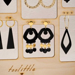 Stand with handmade pairs of earrings with gold-plating and plexiglass parts Stand with handmade pairs of earrings with gold-plating and plexiglass parts
